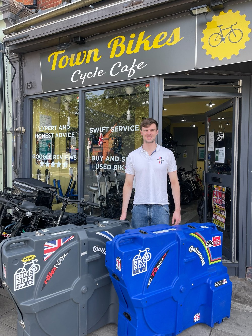 James, co-founder of Bike Box Hire UK, with two boxes outside a hub